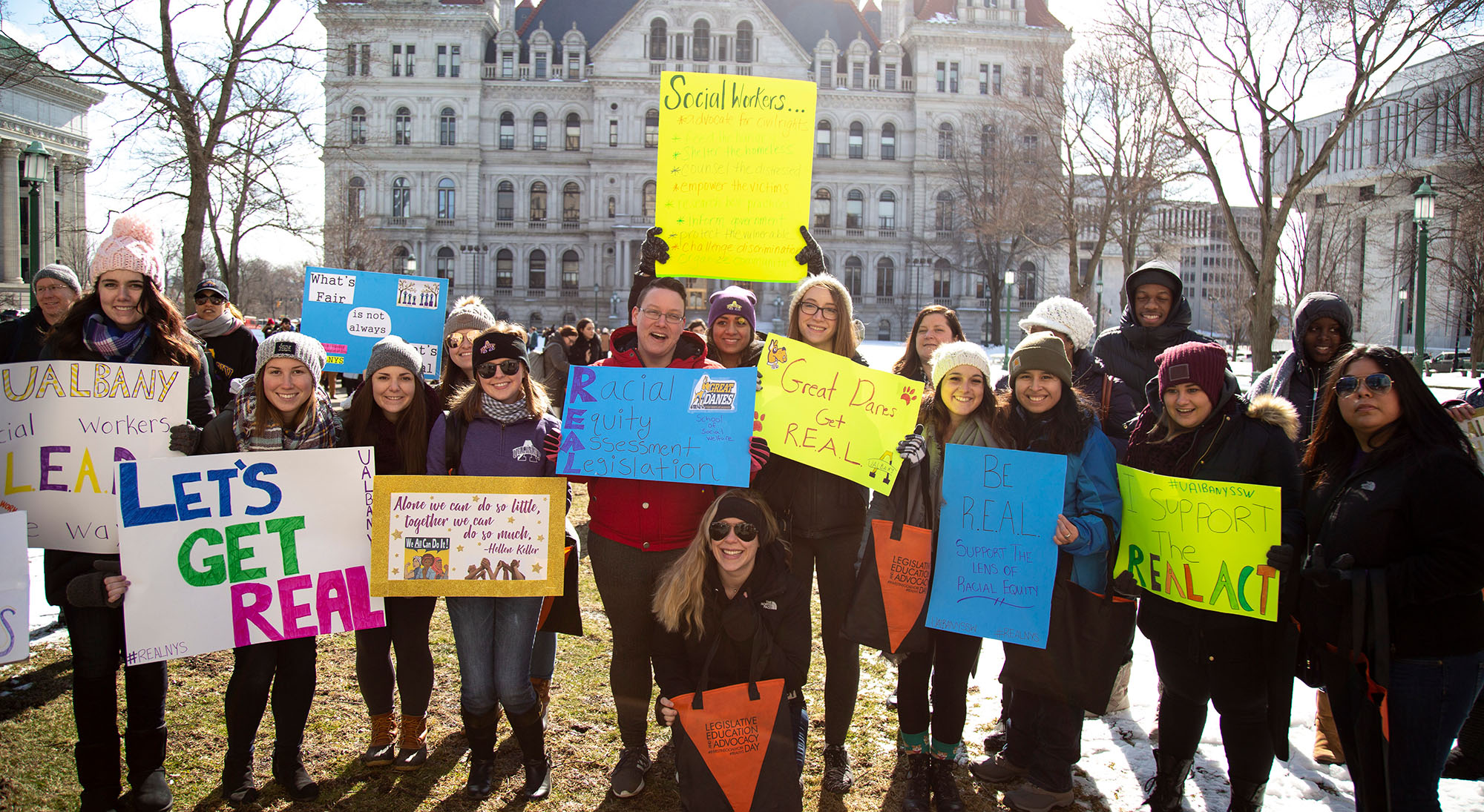 SSW students holding advocacy posters while attending LEAD Day at the New York State Capitol