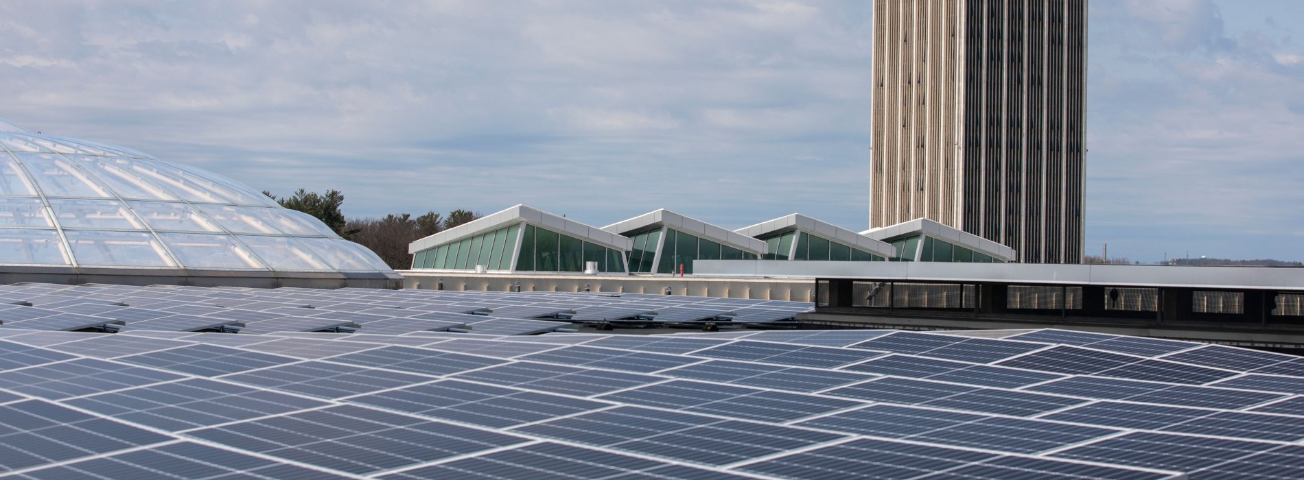 Solar panels on top of the Campus Center building, with one of the residential towers in the background.